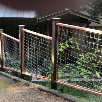 Hog wire (4 gauge) panel fence borders driveway