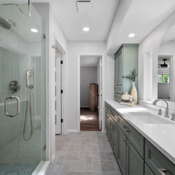 Elegant Bathroom with Arched Mirror and Green Vanity