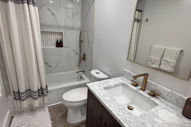 Small beach style porcelain tile vinyl floor, beige floor and single-sink bathroom photo in Miami with flat-panel cabinets, dark wood cabinets, a two-piece toilet, white walls, an undermount sink, quartz countertops, multicolored countertops, a niche and a freestanding vanity