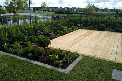 Inspiration for a mid-sized mediterranean backyard full sun formal garden in Auckland with decking.