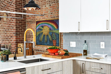 Eat-in kitchen - large modern l-shaped light wood floor eat-in kitchen idea in DC Metro with an undermount sink, flat-panel cabinets, white cabinets, quartzite countertops, blue backsplash, glass tile backsplash, stainless steel appliances, an island and white countertops