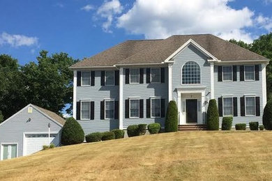 Large elegant gray two-story wood exterior home photo in Boston with a shingle roof