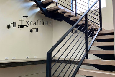 Photo of a modern wood floating metal railing staircase in Boise.