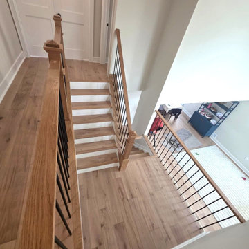Metal and Wood Indoor Railing Installation with Red Oak T-Rail & Black Balusters