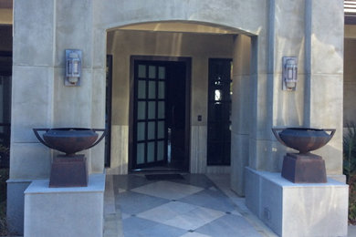 Minimalist marble floor and gray floor single front door photo in Los Angeles with gray walls and a metal front door