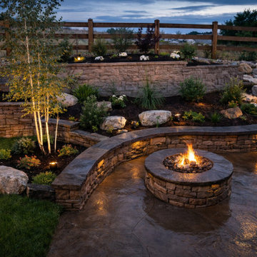 Luxury Backyard Fire Pit Patio with Curved Stone Seating & Landscape Lighting