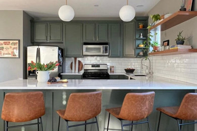 Inspiration for a mid-sized u-shaped eat-in kitchen remodel in Chicago with green cabinets, white backsplash, subway tile backsplash, stainless steel appliances, no island and white countertops