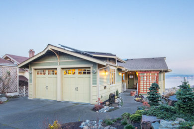 Photo of a mid-sized arts and crafts two-storey multi-coloured house exterior in Seattle with concrete fiberboard siding, a gable roof and a shingle roof.