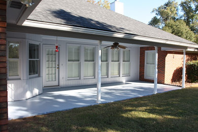 Photo of a mid-sized traditional one-storey brick brown house exterior in Atlanta with a hip roof and a shingle roof.