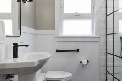 Bathroom - small transitional black and white tile and ceramic tile porcelain tile, black floor, single-sink and wainscoting bathroom idea in San Francisco with a one-piece toilet, gray walls, a pedestal sink and a niche