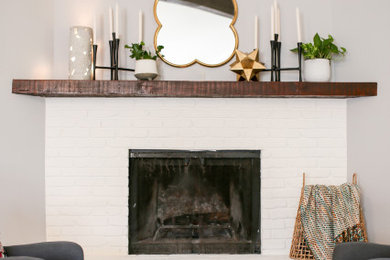 Example of a mid-sized eclectic loft-style bedroom design in Dallas with a standard fireplace and a brick fireplace