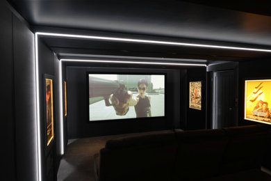 Photo of a modern home cinema in Other with grey walls, carpet and grey floors.