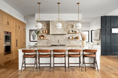 Eat-in kitchen - mid-sized transitional medium tone wood floor and brown floor eat-in kitchen idea in Denver with an undermount sink, shaker cabinets, medium tone wood cabinets, marble countertops, beige backsplash, marble backsplash, stainless steel appliances, an island and beige countertops
