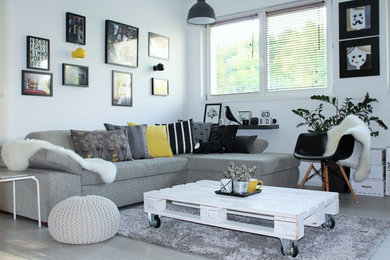 Mid-sized minimalist open concept light wood floor living room photo in Other with white walls