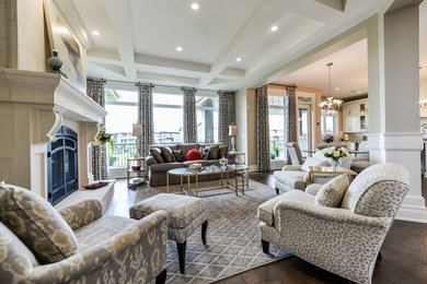 This is an example of a mid-sized transitional open concept living room in Calgary with beige walls and dark hardwood floors.