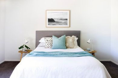 Design ideas for a contemporary master bedroom in Sunshine Coast with white walls and carpet.