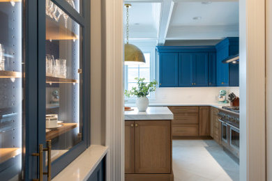 Home bar - large transitional l-shaped porcelain tile home bar idea in Chicago with an undermount sink, blue cabinets, quartz countertops, multicolored backsplash, subway tile backsplash and white countertops