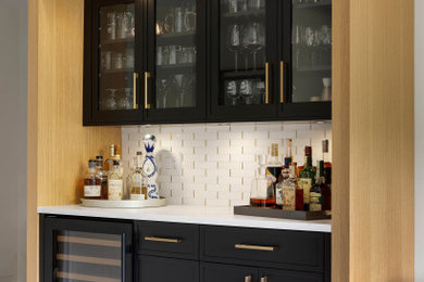 Inspiration for a small mid-century modern single-wall carpeted and gray floor dry bar remodel in Minneapolis with no sink, recessed-panel cabinets, black cabinets, quartz countertops, white backsplash, marble backsplash and white countertops