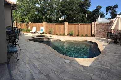 Small traditional backyard custom-shaped lap pool in New Orleans with a hot tub and decking.