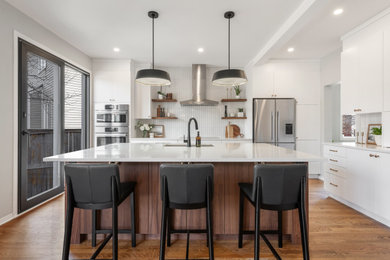 Inspiration for a mid-sized 1960s l-shaped medium tone wood floor eat-in kitchen remodel in Ottawa with an undermount sink, flat-panel cabinets, medium tone wood cabinets, quartz countertops, gray backsplash, ceramic backsplash, stainless steel appliances, an island and white countertops