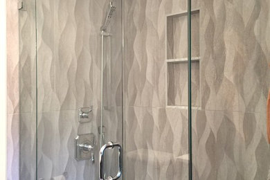 Corner shower - mid-sized contemporary master beige tile and porcelain tile porcelain tile corner shower idea in New York with flat-panel cabinets, brown cabinets, a two-piece toilet, beige walls, an integrated sink and quartzite countertops