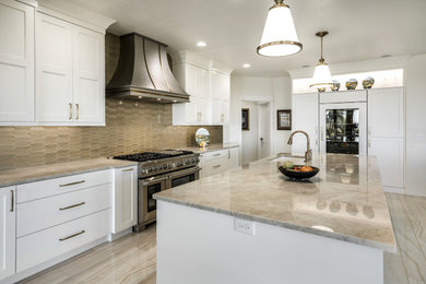 Design ideas for an expansive contemporary galley open plan kitchen in Boise with an undermount sink, shaker cabinets, white cabinets, quartzite benchtops, beige splashback, glass tile splashback, stainless steel appliances, porcelain floors, with island, beige floor and beige benchtop.