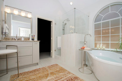Large transitional master beige tile and porcelain tile porcelain tile and beige floor bathroom photo in Dallas with shaker cabinets, gray cabinets, a one-piece toilet, beige walls, an undermount sink, granite countertops and a hinged shower door