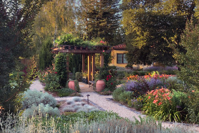 Inspiration for an expansive mediterranean backyard full sun formal garden for summer in San Francisco with a garden path, gravel and a wood fence.