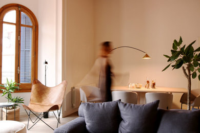 Imagen de salón abierto y beige y blanco actual de tamaño medio con paredes blancas, suelo de madera clara, pared multimedia, suelo beige y vigas vistas