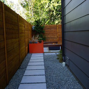 Inspiration for a mid-sized modern backyard shaded xeriscape in Seattle.