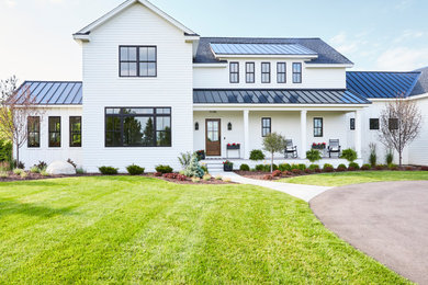 Example of a farmhouse exterior home design in Minneapolis