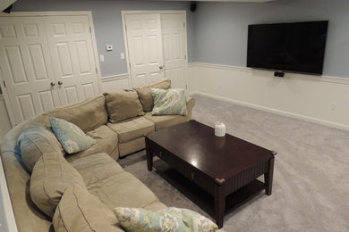 Mid-sized elegant underground carpeted basement photo in Boston with blue walls and a standard fireplace