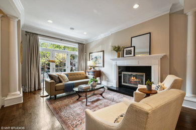 Mid-sized elegant open concept brown floor living room photo in Chicago with beige walls, a standard fireplace and a wood fireplace surround
