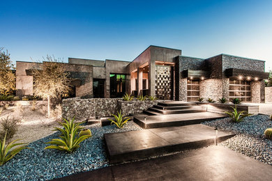 Example of a large minimalist gray one-story concrete exterior home design in Las Vegas