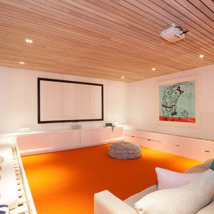 This is an example of a medium sized contemporary enclosed home cinema in Sydney with white walls, carpet, a projector screen and orange floors.