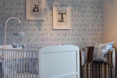 Design ideas for a traditional nursery for boys in London with blue walls and carpet.