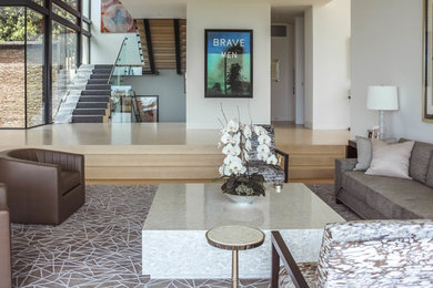 Large trendy open concept beige floor and light wood floor living room photo in Los Angeles with white walls and no tv