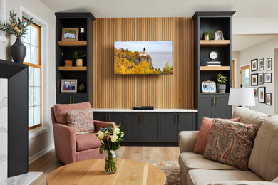 Mid-sized transitional open concept vinyl floor, brown floor and wall paneling living room photo in Minneapolis with black walls, a standard fireplace and a media wall