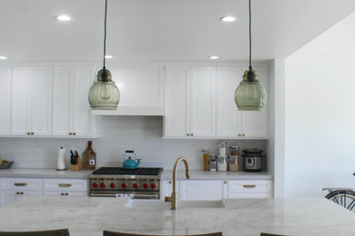 Example of a transitional kitchen design in Orange County with an island