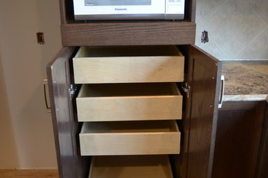Example of a mid-sized trendy u-shaped kitchen design in Calgary with shaker cabinets, ceramic backsplash and a peninsula