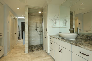 Mid-sized transitional master bathroom in Portland with flat-panel cabinets, white cabinets, a curbless shower, a vessel sink, granite benchtops, a hinged shower door, beige benchtops, beige tile, blue walls, ceramic floors and beige floor.