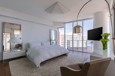 Design ideas for a large modern master bedroom in Miami with white walls and medium hardwood floors.