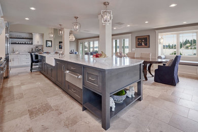 Large transitional kitchen photo in Seattle with a farmhouse sink, gray cabinets, marble countertops, white backsplash, subway tile backsplash, stainless steel appliances and an island