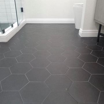 Beautiful, sleek, curb-less white and black shower and tub bathroom