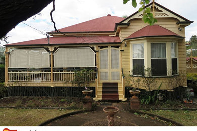 Photo of a traditional home design in Brisbane.