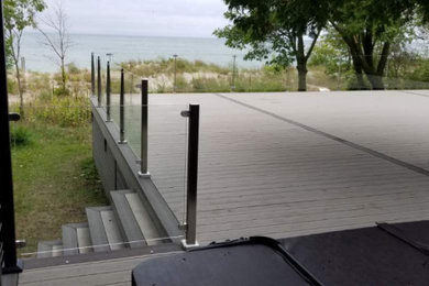 Deck - huge backyard glass railing deck idea in Toronto