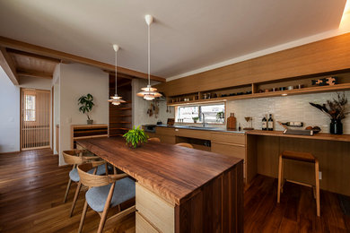 Single-wall kitchen/diner in Other with an integrated sink, flat-panel cabinets, stainless steel worktops, stainless steel appliances and medium hardwood flooring.