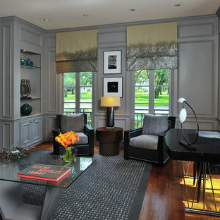 This is an example of a victorian home office and library in Houston with grey walls, dark hardwood flooring, a freestanding desk and brown floors.