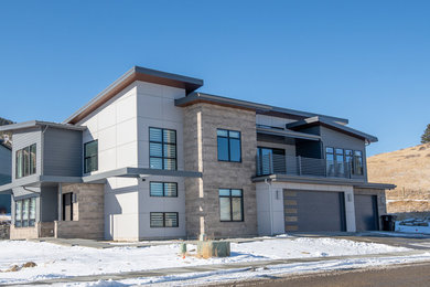 Large contemporary gray two-story mixed siding house exterior idea in Other with a shed roof and a metal roof