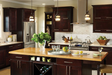Elegant u-shaped eat-in kitchen photo in DC Metro with an undermount sink, shaker cabinets, dark wood cabinets, wood countertops, white backsplash, mosaic tile backsplash and stainless steel appliances
